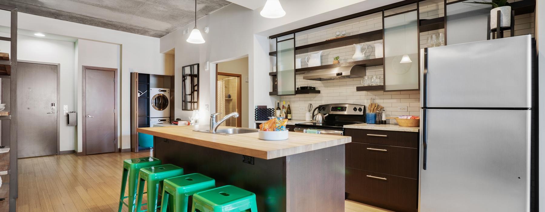 a kitchen with an island and bar stools