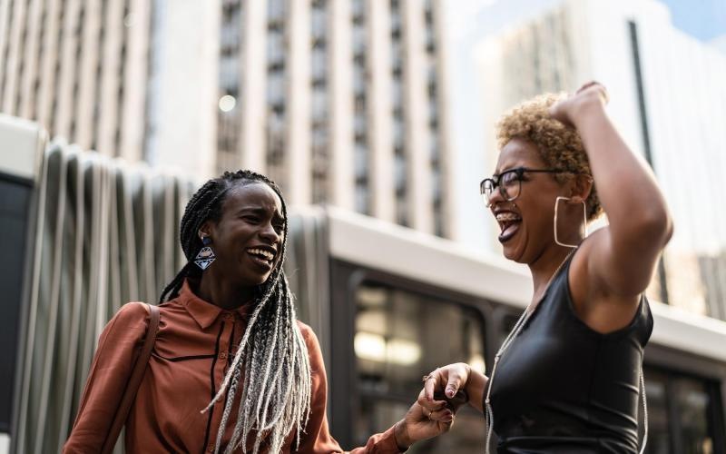 women laughing together in the city