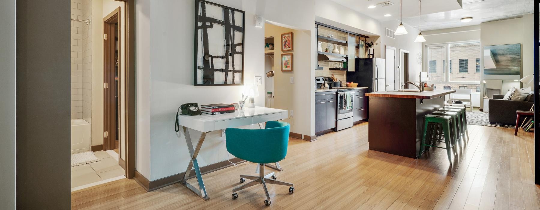 Interior view of the study area and kitchen of a one-bedroom Philly apartment at The Granary