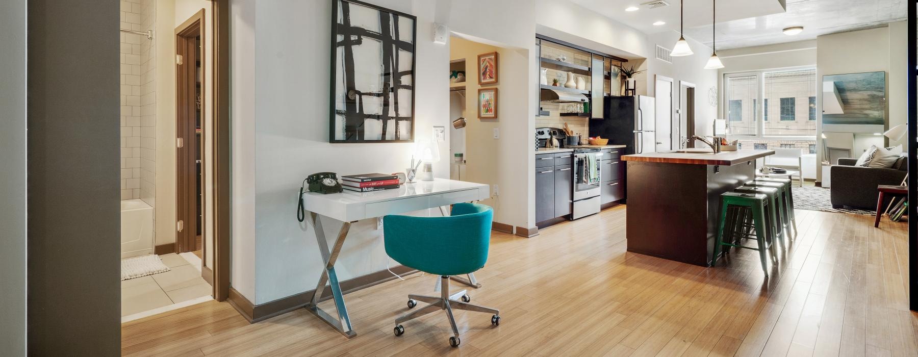 a kitchen with a small desk and chair